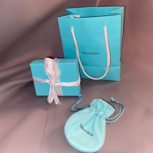 Original Tiffany box, bag and dust bag.